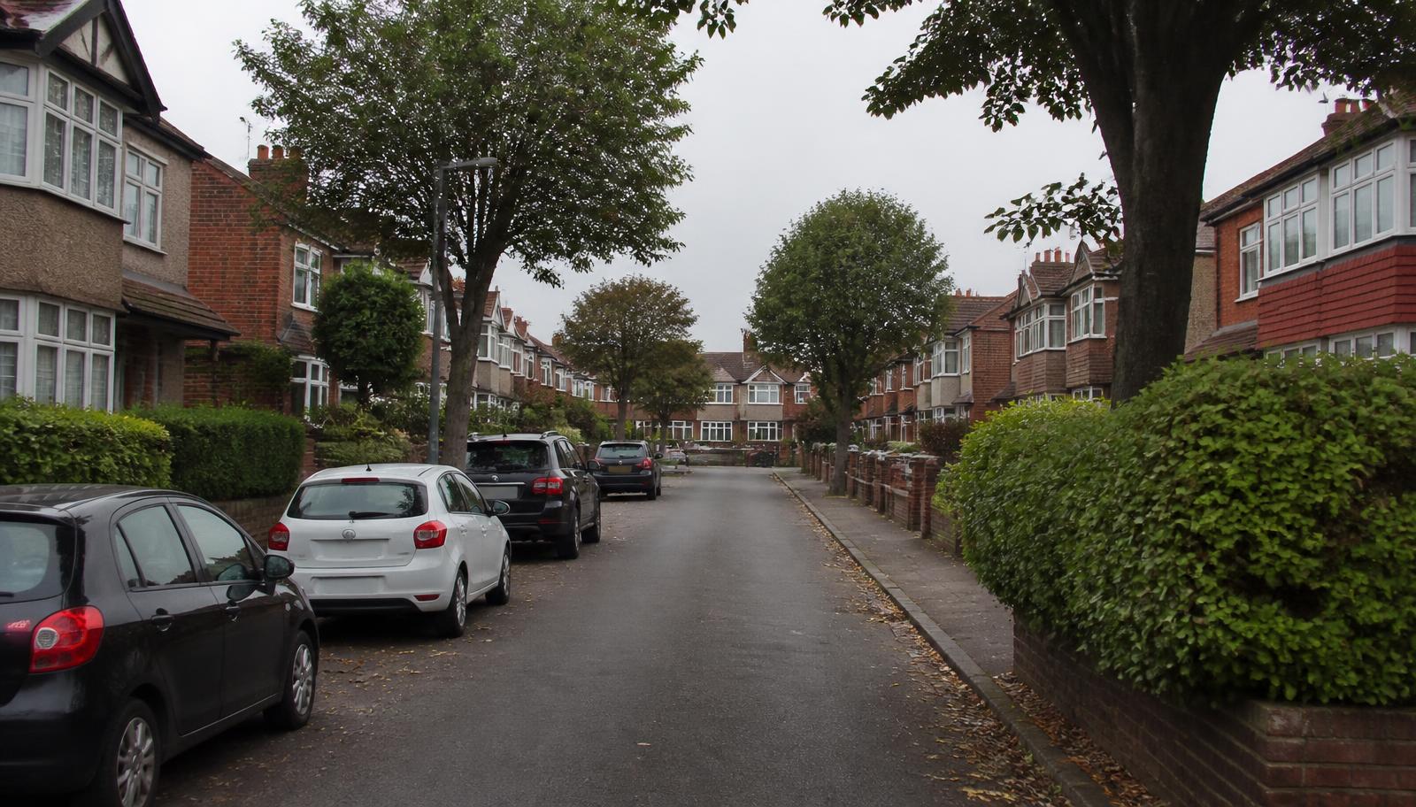 Quiet Hertfordshire residential street of brick and pebbledash houses