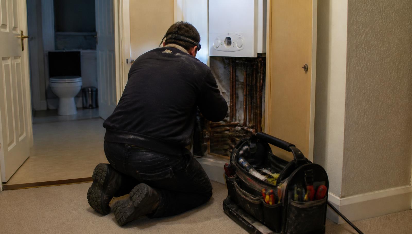 Qualified engineer diagnosing a boiler breakdown