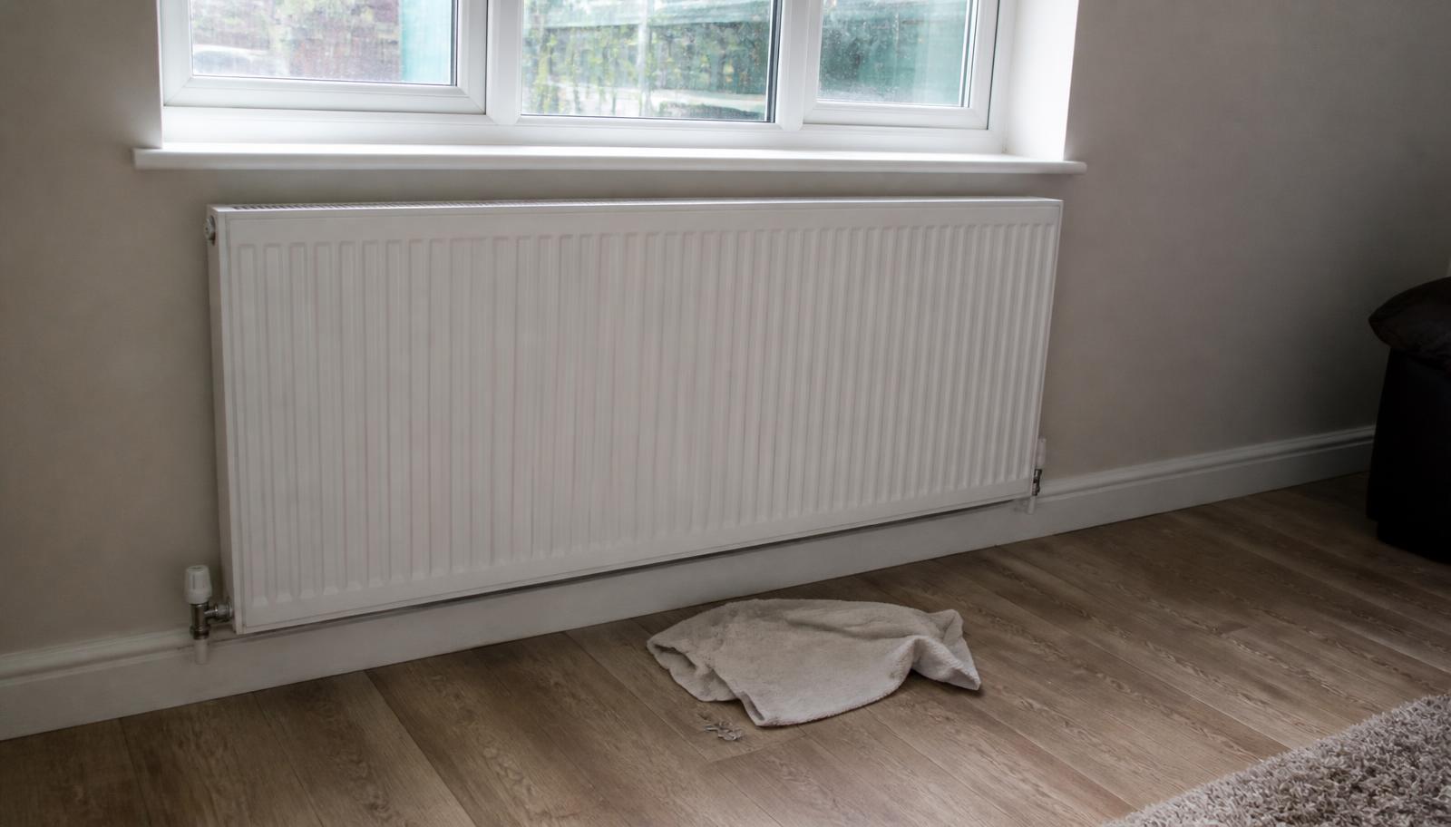 White panel radiator fitted under a UPVC window in a Hertfordshire home